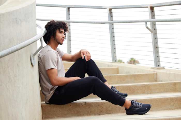 Jared McCain sits on steps in a photo shoot.