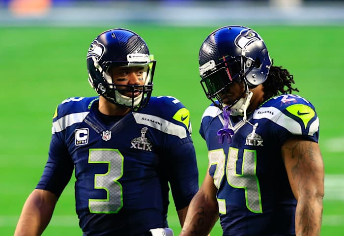 Seattle Seahawks quarterback Russell Wilson (3) talks with Seattle Seahawks running back Marshawn Lynch (24) in Super Bowl XLIX at University of Phoenix Stadium.