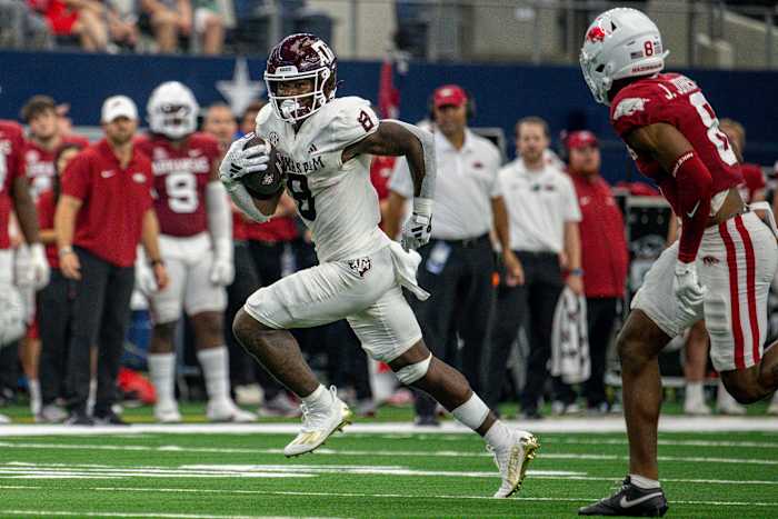 Texas A&M Aggies running back Le'Veon Moss (8) and Arkansas Razorbacks defensive back Jayden Johnson (8) In action during the game between the Texas A&M Aggies and the Arkansas Razorbacks at AT&T Stadium