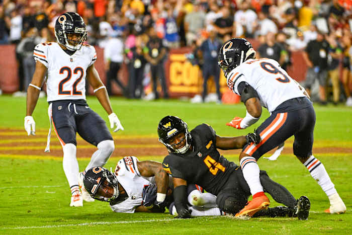 Chicago Bears cornerback Greg Stroman Jr. (27) intercepts a pass over Washington Commanders wide receiver Curtis Samuel (4) during the first half at FedExField.