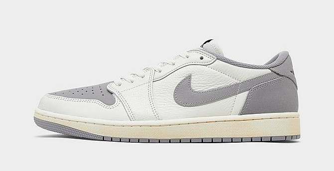 Side view of white and grey Air Jordan sneakers.