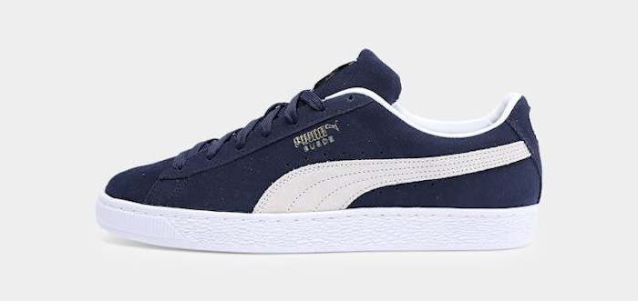 Side view of a navy and white PUMA sneaker.