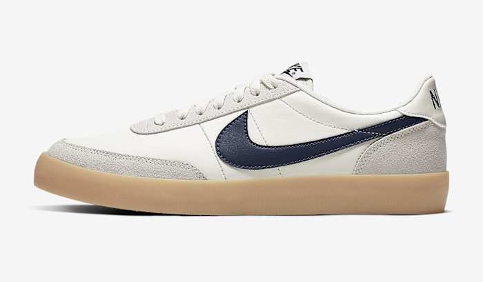 Side view of a white, navy, and tan Nike sneaker.