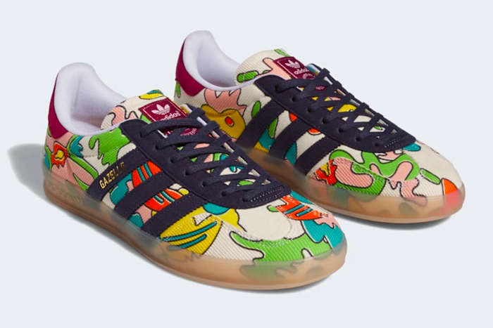 Side view of navy and green adidas sneakers.