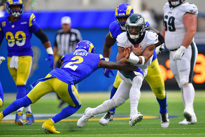 Philadelphia Eagles quarterback Jalen Hurts (1) runs the ball against Los Angeles Rams safety Russ Yeast (2) during the first half at SoFi Stadium.