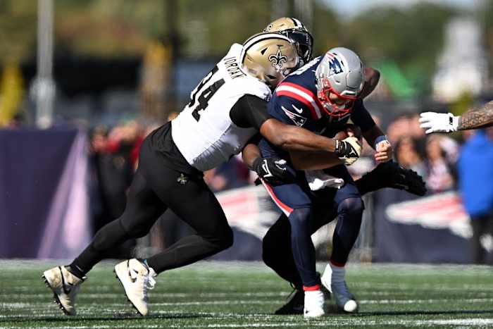 New England Patriots quarterback Mac Jones (10) is sacked by New Orleans Saints defensive ends Tanoh Kpassagnon (92) and Cameron Jordan (94). Mandatory Credit: Brian Fluharty-USA TODAY