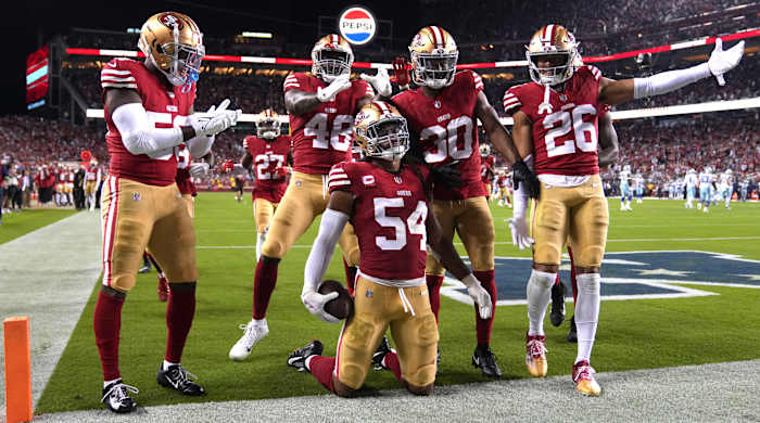 San Francisco 49ers linebacker Fred Warner (54) poses with teammates after intercepting a pass against the Dallas Cowboys