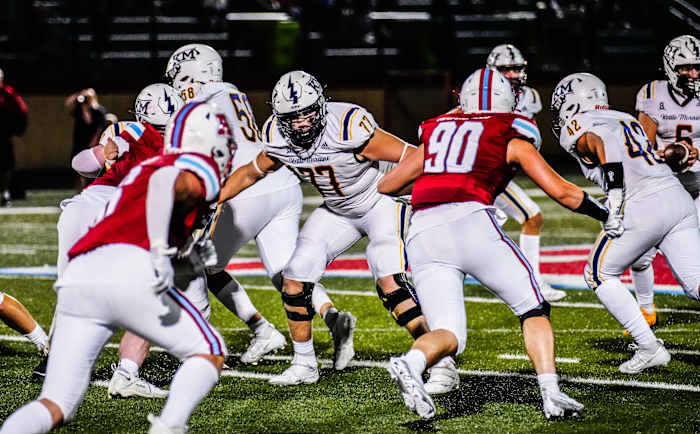 Kettle Moraine offensive lineman Brayden Thompson (77) holds off multiple defenders during the game at Arrowhead on Friday, Sept. 1, 2023.