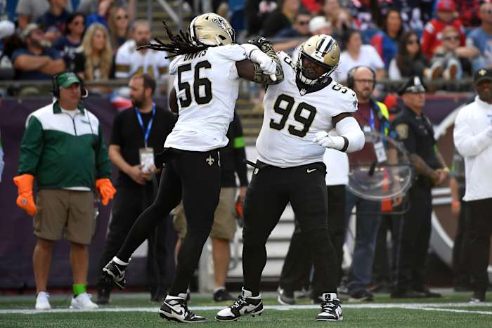 Saints' Demario Davis and Khalen Saunders react after a fourth down stop against the New England Patriots during the second half at Gillette Stadium