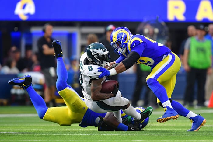 Oct 8, 2023; Inglewood, California, USA; Philadelphia Eagles running back D'Andre Swift (0) is brought down by Los Angeles Rams defensive tackle Aaron Donald (99) during the second half at SoFi Stadium. Mandatory Credit: Gary A. Vasquez-USA TODAY Sports