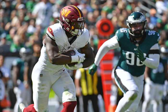 Washington Commanders running back Brian Robinson Jr. (8) runs with the football against the Philadelphia Eagles during the first quarter at Lincoln Financial Field.