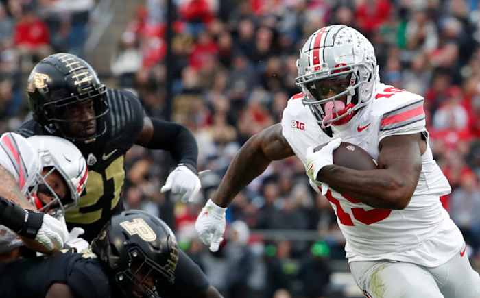 Ohio State running back Chip Trayanum (No. 19) evades two Purdue defensive lineman at Ross-Ade Stadium