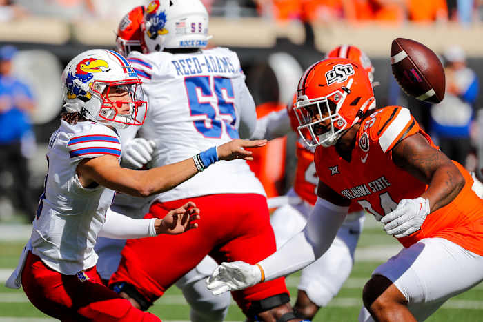 Oct 14, 2023; Stillwater, Oklahoma, USA; Kansas Jayhawks s Jason Bean (9) pitches the ball in the first quarter against the Oklahoma State Cowboys at Boone Pickens Stadium.