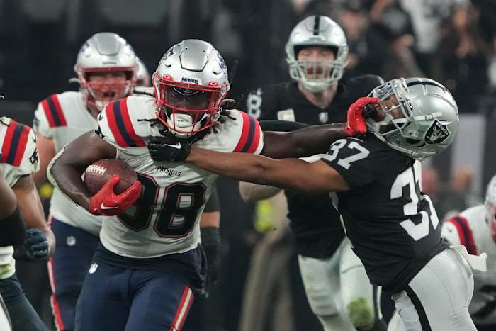 Dec 18, 2022; Paradise, Nevada, USA; New England Patriots running back Rhamondre Stevenson (38) carriies the ball against Las Vegas Raiders cornerback Tyler Hall (37) in the second half at Allegiant Stadium. The Raiders defeated the Patriots 30-24.