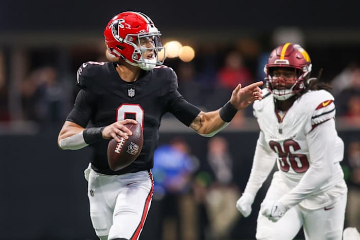 Oct 15, 2023; Atlanta, Georgia, USA; Atlanta Falcons quarterback Desmond Ridder (9) scrambles past Washington Commanders defensive end James Smith-Williams (96) in the first quarter at Mercedes-Benz Stadium.