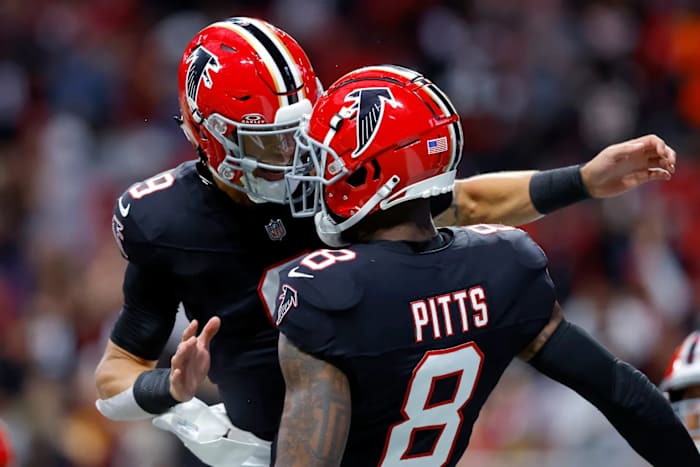 Atlanta Falcons quarterback Desmond Ridder celebrates with tight end Kyle Pitts.