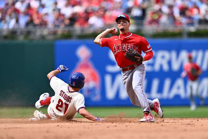 Aug 30, 2023; Philadelphia, Pennsylvania, USA; Los Angeles Angels shortstop Andrew Velazquez (4) turns a double play over Philadelphia Phillies catcher Garrett Stubbs (21) in the fourth inning at Citizens Bank Park.