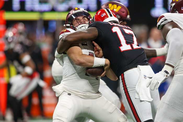Oct 15, 2023; Atlanta, Georgia, USA; Washington Commanders quarterback Sam Howell (14) is sacked by Atlanta Falcons linebacker Arnold Ebiketie (17) in the second half at Mercedes-Benz Stadium. Mandatory Credit: Brett Davis-USA TODAY Sports