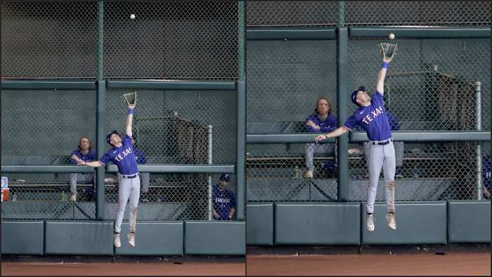 Texas Rangers left fielder Evan Carter makes a catch at the wall during the eighth inning of ALCS Game 1 against the Houston Astros Sunday night to start a double play at Minute Maid Park