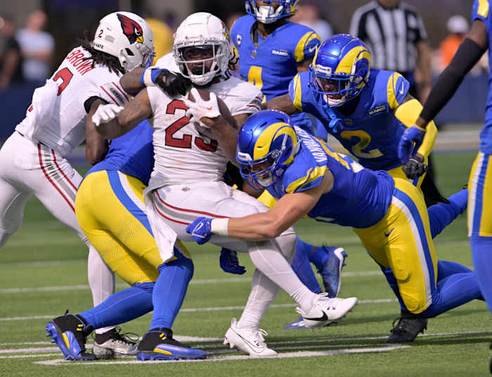 The Los Angeles Rams defense swarms the Cardinals ball carrier