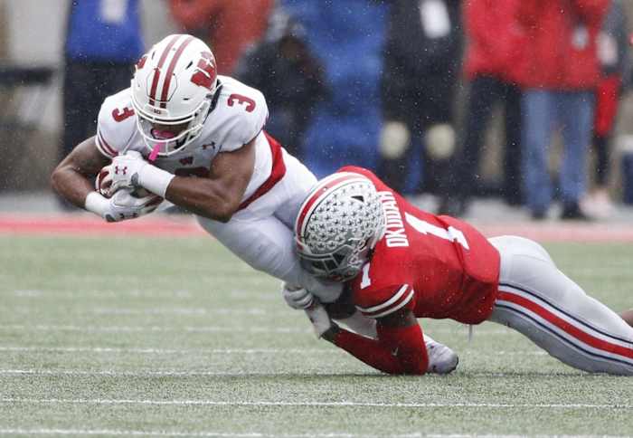 Ohio State Buckeyes cornerback Jeff Okudah (1) tackles Wisconsin Badgers wide receiver Kendric Pryor (3) during the first quarter of a NCAA Division I college football game between the Ohio State Buckeyes and the Wisconsin Badgers on Saturday, October 26, 2019 at Ohio Stadium in Columbus, Ohio. [Joshua A. Bickel/Dispatch] Osu19wis Jb 30