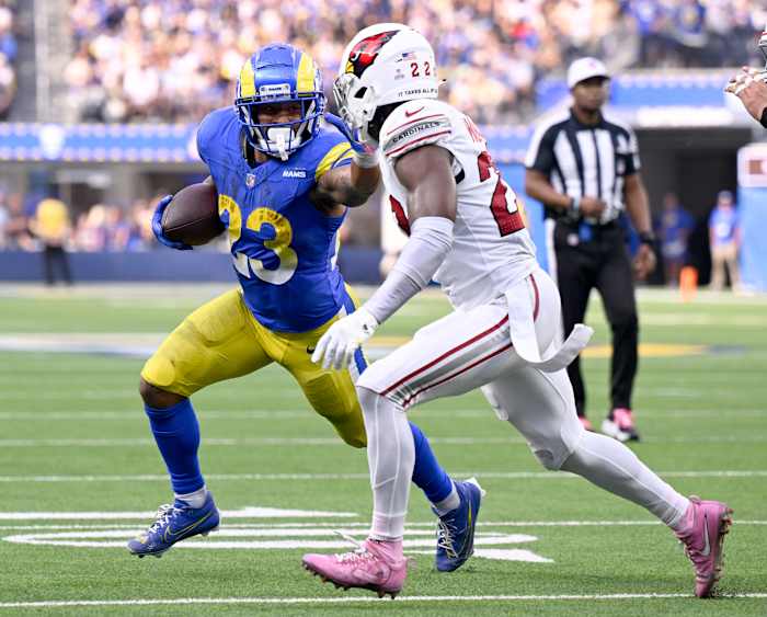 Oct 15, 2023; Inglewood, California, USA; Los Angeles Rams running back Kyren Williams (23) avoids Arizona Cardinals safety K'Von Wallace (22) to score a touchdown during the second half at SoFi Stadium. Mandatory Credit: Alex Gallardo-USA TODAY Sports