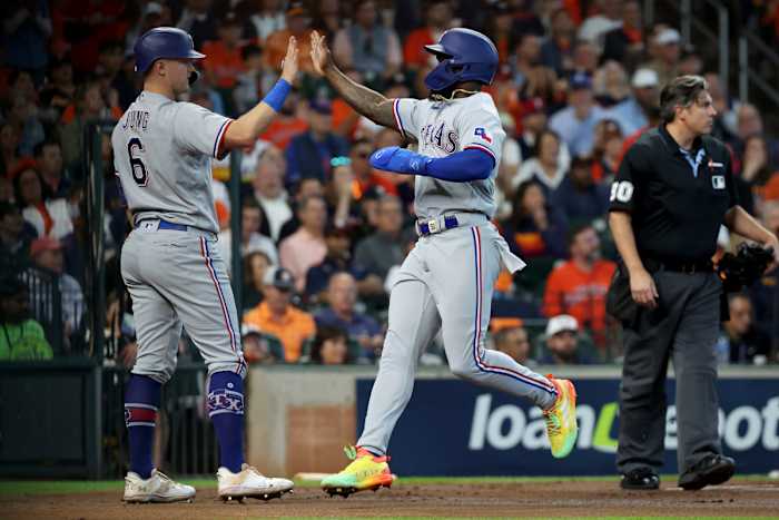 Texas Rangers right fielder Adolis Garcia, right, celebrates with third baseman Josh Jung after scoring in the first inning against the Houston Astros during Game 2 of the ALCS Monday at Minute Maid Park.