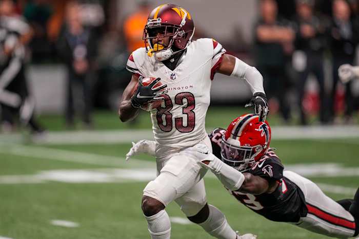 Washington Commanders wide receiver Jamison Crowder (83) is tackled by Atlanta Falcons cornerback Tre Flowers (33) after a long punt return during the first half at Mercedes-Benz Stadium.