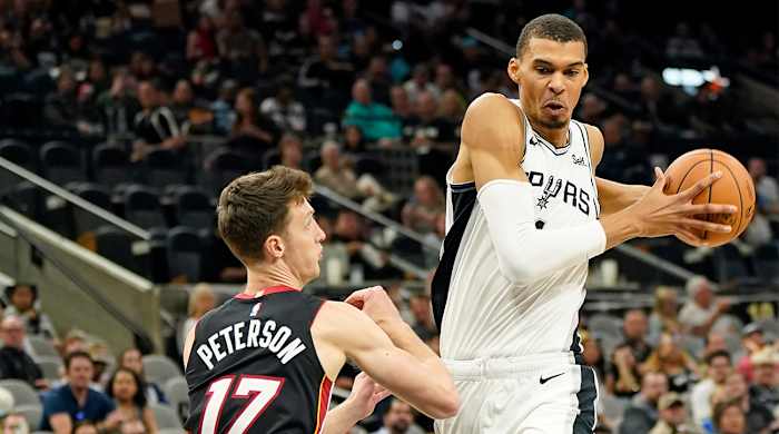 Spurs’ Victor Wembanyama drives to the basket vs. the Heat in an NBA preseason game.