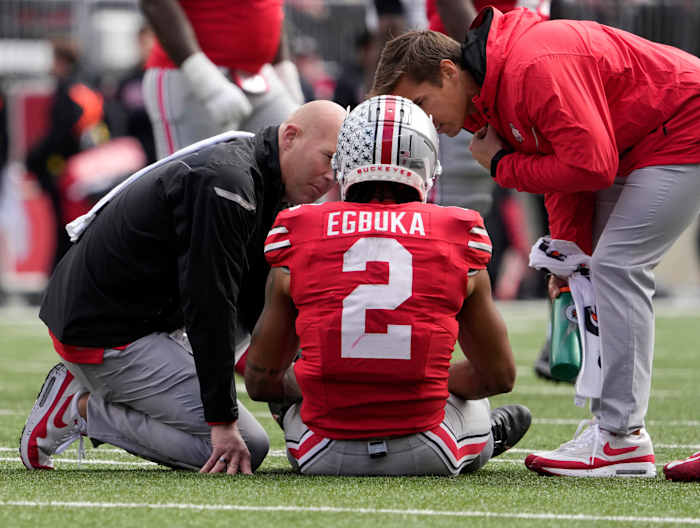 Ohio State Buckeyes wide receiver Emeka Egbuka (2) is attended to on the field during the second half of Saturday's NCAA Division I football game against the Maryland Terrapins at Ohio Stadium