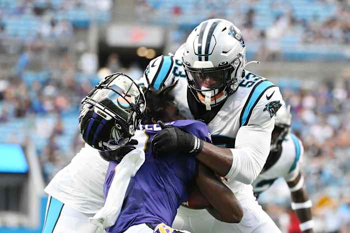 Aug 21, 2021; Charlotte, North Carolina, USA; Carolina Panthers defensive end Brian Burns (53) knocks off the helmet of Baltimore Ravens quarterback Tyler Huntley (2) during a tackle in the first quarter at Bank of America Stadium.