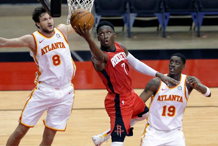 Rockets guard Victor Oladipo puts up a shot between Atlanta Hawks forward Danilo Gallinari and Atlanta Hawks guard Tony Snell.
