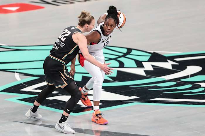 Las Vegas Aces guard Chelsea Gray dribbles past New York Liberty guard Courtney Vandersloot.