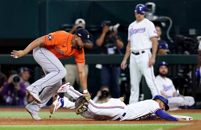 Houston Astros first baseman Jose Abreu tags out Texas Rangers second baseman Marcus Semien for a double play in the fifth inning of Game 4 of the ALCS Thursday night at Globe Life Field.