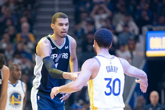 San Antonio Spurs center Victor Wembanyama (1) shakes hands with Golden State Warriors guard Stephen Curry (30) before the game at Chase Center.
