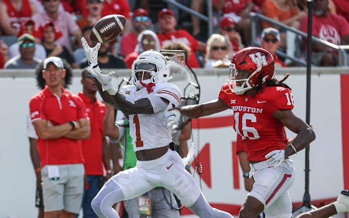 Texas Longhorns wide receiver Xavier Worthy (1) makes a reception for a touchdown as Houston Cougars defensive back Brian George (16) defends during the first quarter at TDECU Stadium.