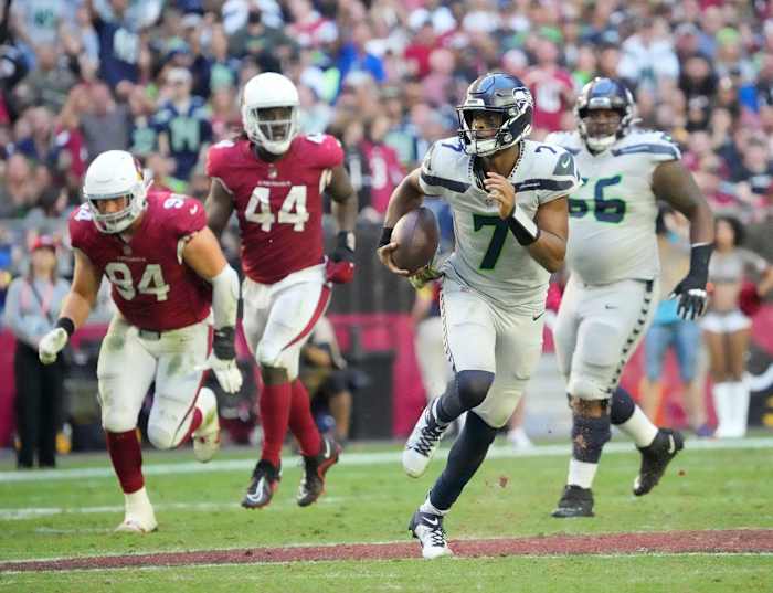 Nov 6, 2022; Phoenix, Ariz., United States; Seattle Seahawks quarterback Geno Smith (7) scrambles away from Arizona Cardinals defensive end Zach Allen (94) and linebacker Markus Golden (44) during the fourth quarter at State Farm Stadium.