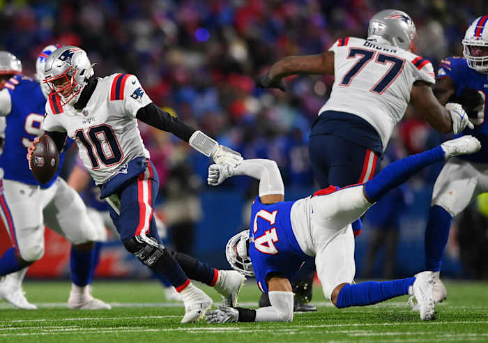 Jan 15, 2022; Orchard Park, New York, USA; New England Patriots quarterback Mac Jones (10) is pressured by Buffalo Bills cornerback Cam Lewis (47) during the fourth quarter of the AFC Wild Card playoff game at Highmark Stadium. The Bills won the game 47-17.