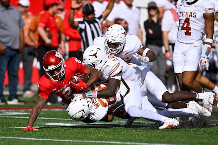 The Texas defense swarms a Houston ball carrier 