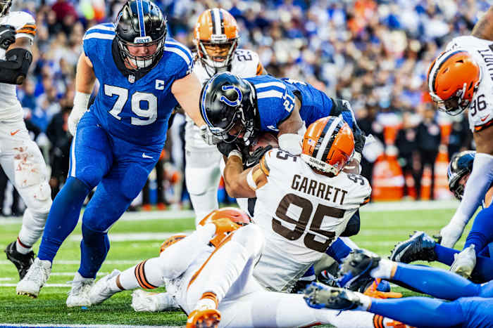 Oct 22, 2023; Indianapolis, Indiana, USA; Indianapolis Colts running back Zack Moss (21) runs the ball while Cleveland Browns defensive end Myles Garrett (95) defends in the second half at Lucas Oil Stadium.
