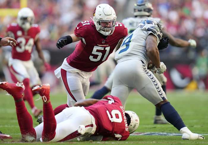Nov 6, 2022; Phoenix, AZ, United States; Arizona Cardinals linebackers Tanner Vallejo (51) and Isaiah Simmons (9) tackle Seattle Seahawks running back Kenneth Walker III (9) at State Farm Stadium.