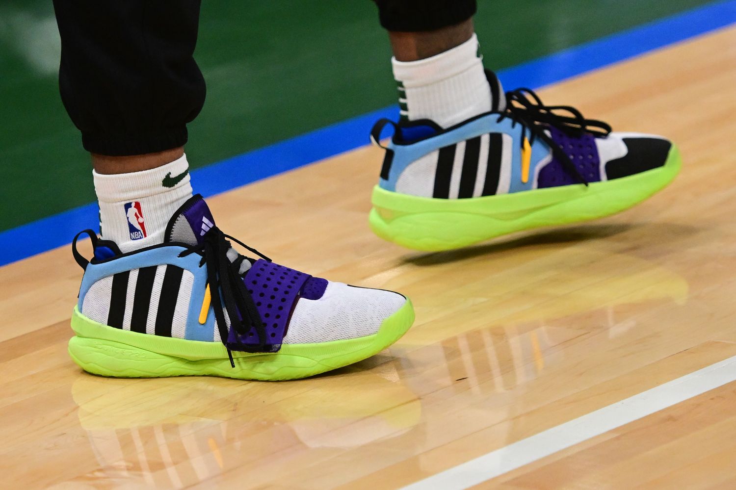 Milwaukee Bucks guard Damian Lillard's black and green adidas shoes.