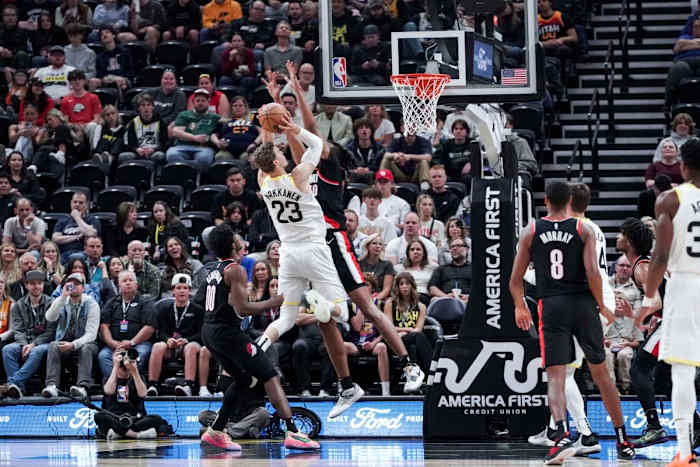 Lauri Markkanen (23) jumps and shoots over Trail Blazers guard Scoot Henderson