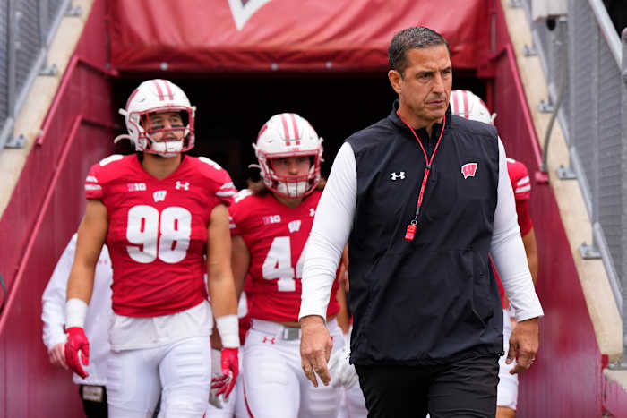 Oct 14, 2023; Madison, Wisconsin, USA; Wisconsin Badgers head coach Luke Fickell leads the football team onto the field for warmups prior to the game against the Iowa Hawkeyes at Camp Randall Stadium. Mandatory Credit: Jeff Hanisch-USA TODAY Sports