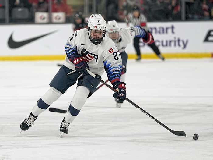 Nov 21, 2021; Kingston, Ontario, CAN; USA forward Britta Curl (27) tries to control a puck against Canada during the first period in a Rivalry Series women's hockey game at Leon's Centre. Mandatory Credit: John E. Sokolowski-USA TODAY Sports