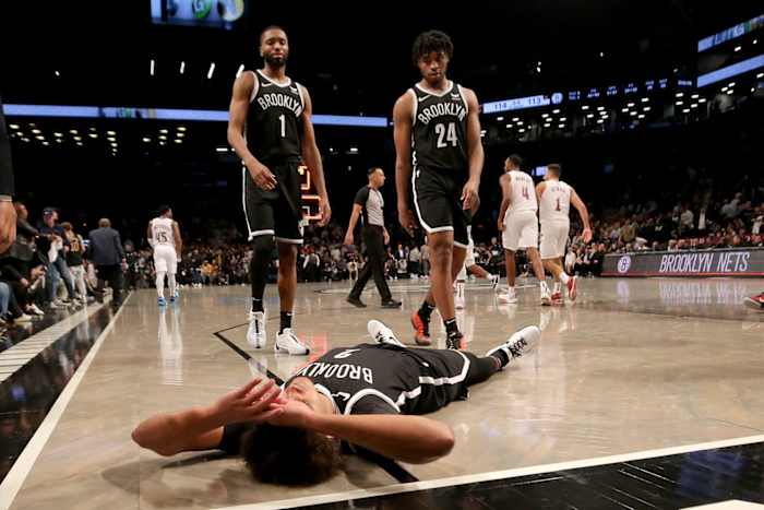 Brooklyn Nets forward Mikal Bridges (1) and guard Cam Thomas (24) walk towards forward Cameron Johnson (2)