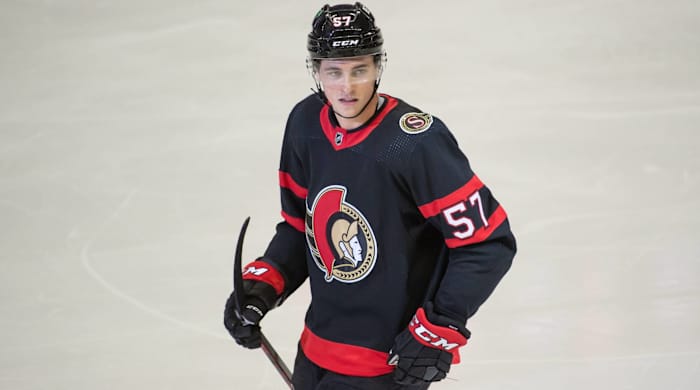 Senators center Shane Pinto looks while holding his stick on during a game.