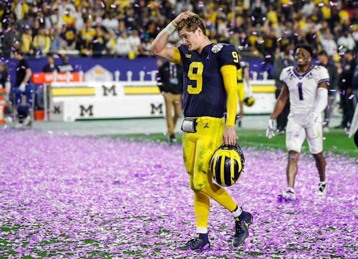 Michigan quarterback J.J. McCarthy (9) walks off the field after the Wolverines lost 51-45 to TCU at the Fiesta Bowl at State Farm Stadium in Glendale, Ariz. on Saturday, Dec. 31, 2022.