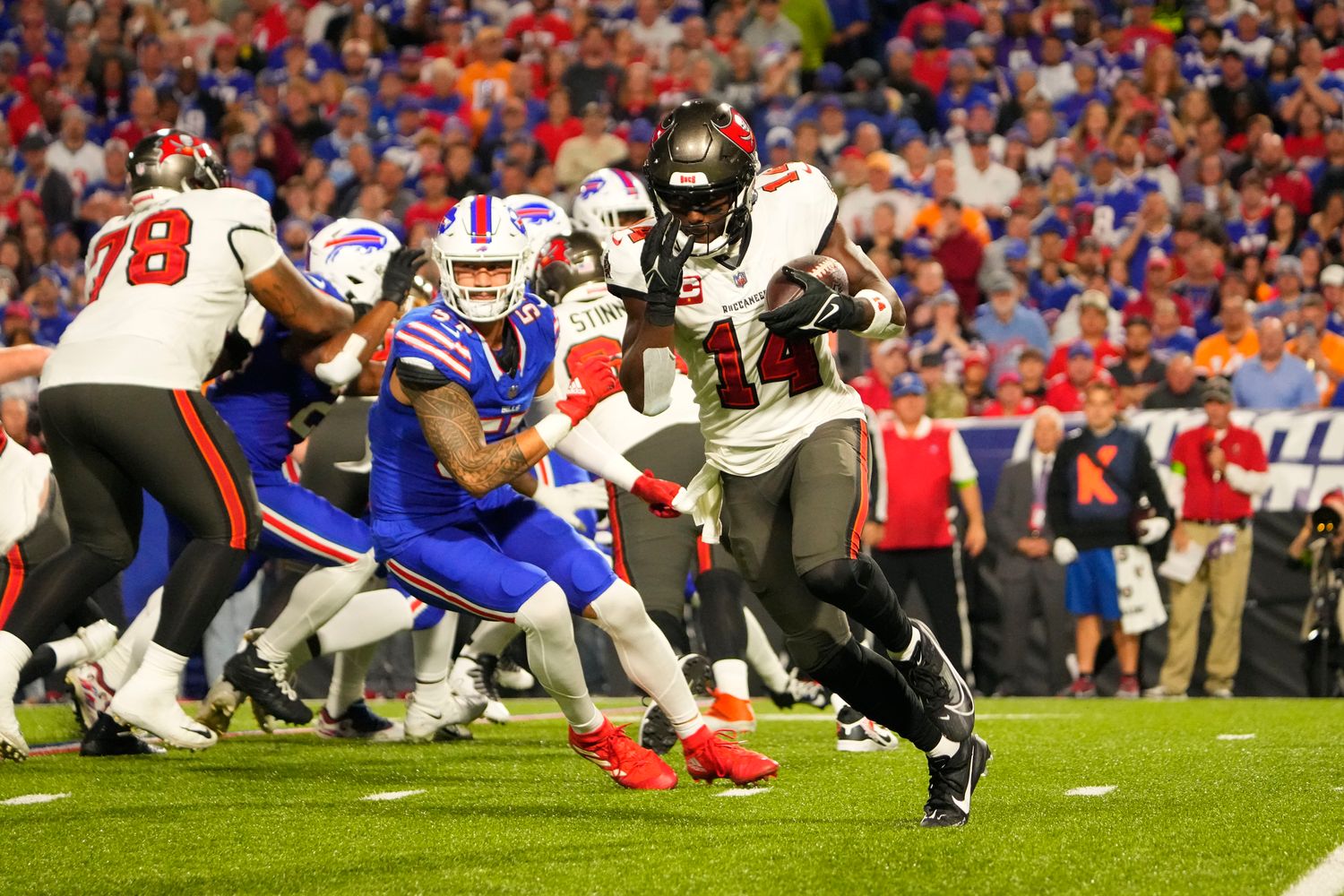 Tampa Bay Buccaneers wide receiver Chris Godwin (14) runs with the ball against the Buffalo Bills during the first half at Highmark Stadium.