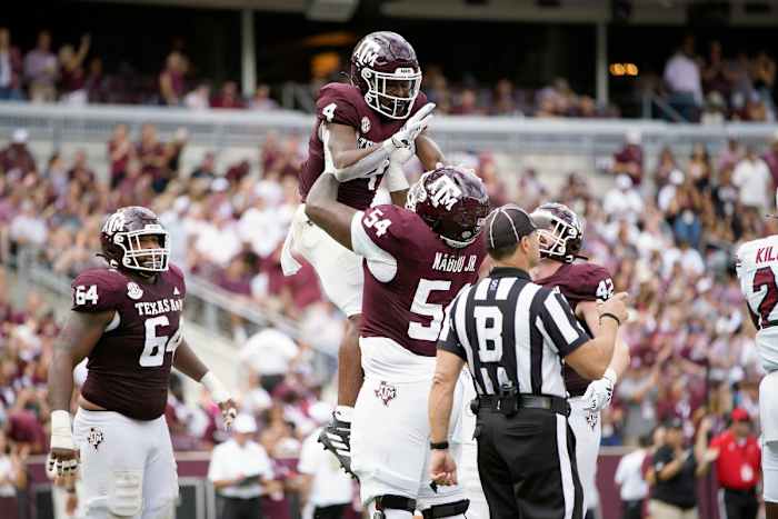 Oct 28, 2023; College Station, Texas, USA; Texas A&M Aggies running back Amari Daniels (4) and offensive lineman Mark Nabou Jr. (54) celebrate during the second quarter against the South Carolina Gamecocks at Kyle Field.